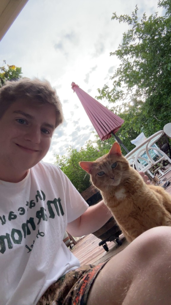 Sevy Smith with his cat on a patio